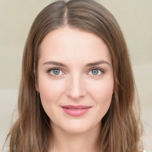 Joyful white young-adult female with long  brown hair and green eyes