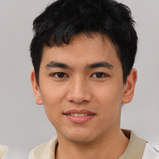 Joyful asian young-adult male with short  black hair and brown eyes