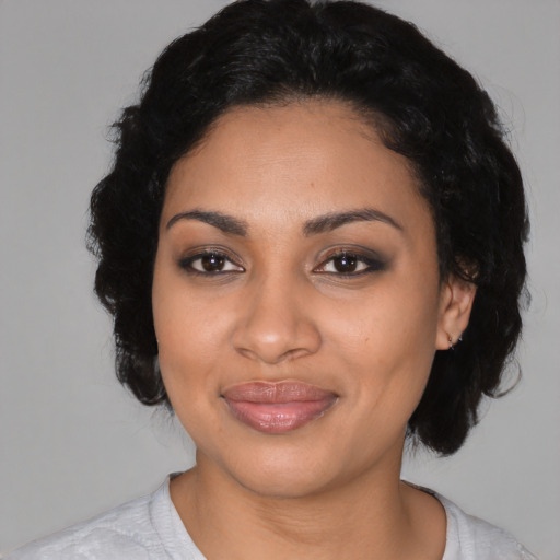 Joyful latino adult female with medium  black hair and brown eyes