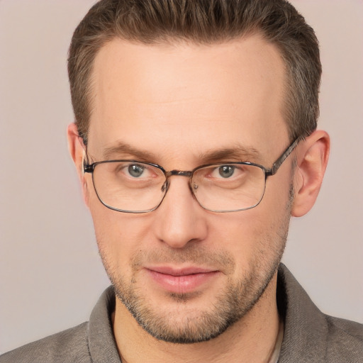 Joyful white adult male with short  brown hair and brown eyes