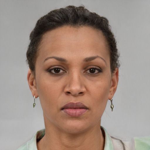 Joyful latino adult female with short  brown hair and brown eyes