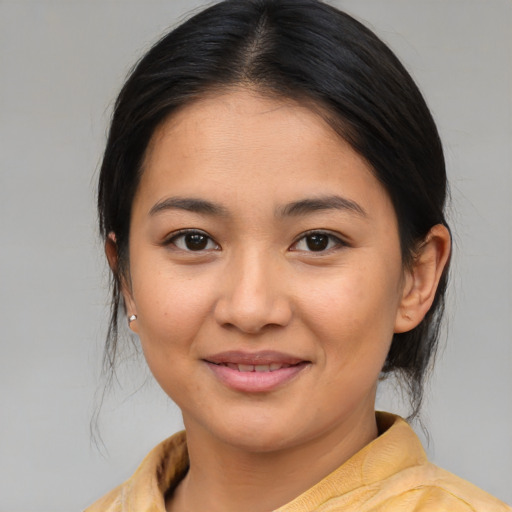 Joyful asian young-adult female with medium  brown hair and brown eyes