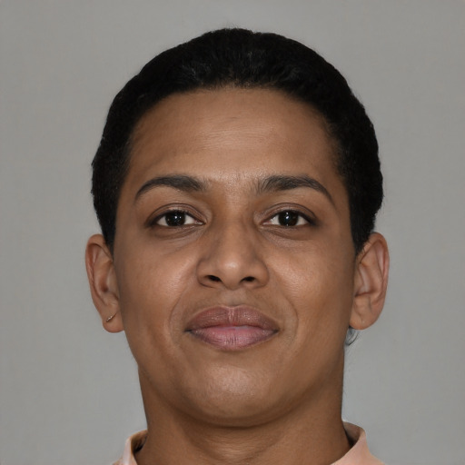 Joyful black young-adult female with short  black hair and brown eyes