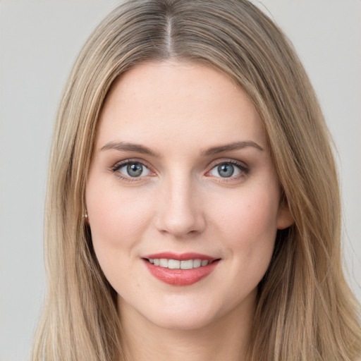 Joyful white young-adult female with long  brown hair and grey eyes