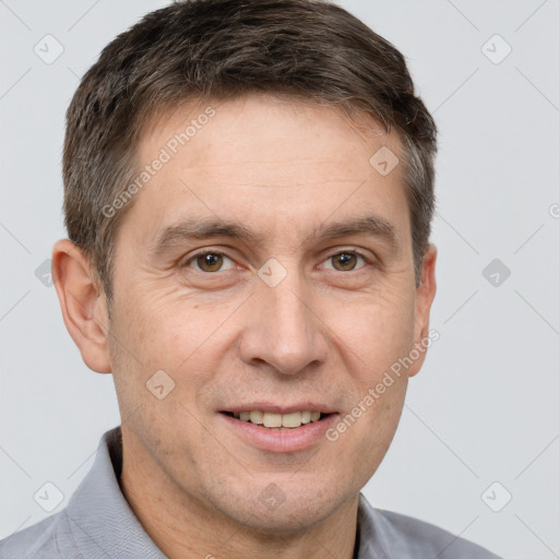 Joyful white adult male with short  brown hair and brown eyes