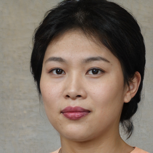 Joyful asian young-adult female with medium  brown hair and brown eyes