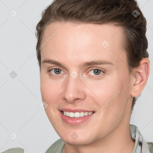 Joyful white young-adult female with short  brown hair and grey eyes