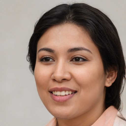 Joyful asian young-adult female with medium  brown hair and brown eyes