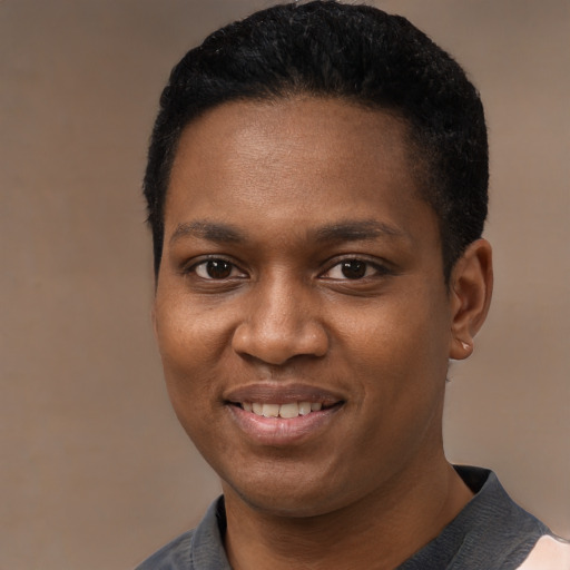 Joyful black young-adult male with short  black hair and brown eyes