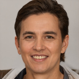 Joyful white adult male with short  brown hair and brown eyes