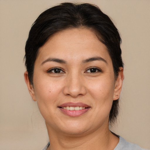 Joyful asian adult female with short  brown hair and brown eyes