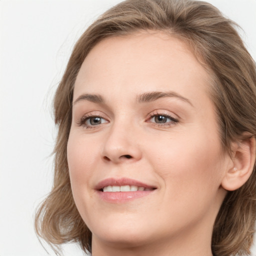 Joyful white young-adult female with medium  brown hair and blue eyes