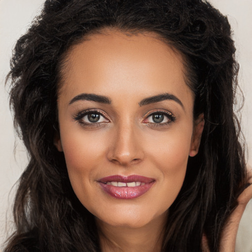 Joyful white young-adult female with long  brown hair and brown eyes