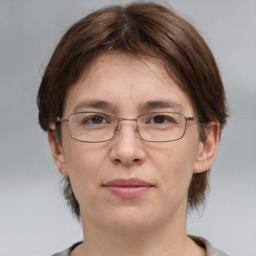 Joyful white adult female with medium  brown hair and grey eyes