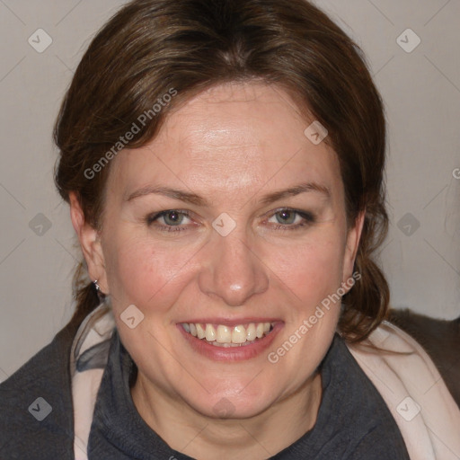 Joyful white adult female with medium  brown hair and blue eyes