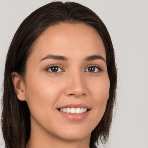 Joyful white young-adult female with long  brown hair and brown eyes