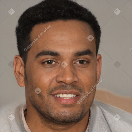 Joyful black young-adult male with short  brown hair and brown eyes