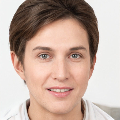 Joyful white young-adult female with short  brown hair and grey eyes