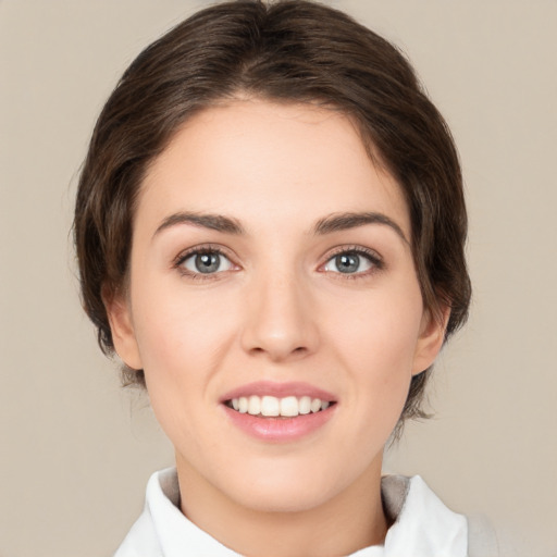 Joyful white young-adult female with medium  brown hair and green eyes