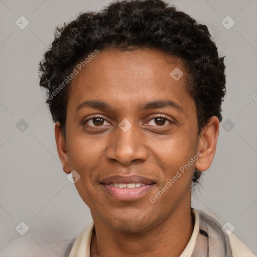 Joyful black adult male with short  brown hair and brown eyes