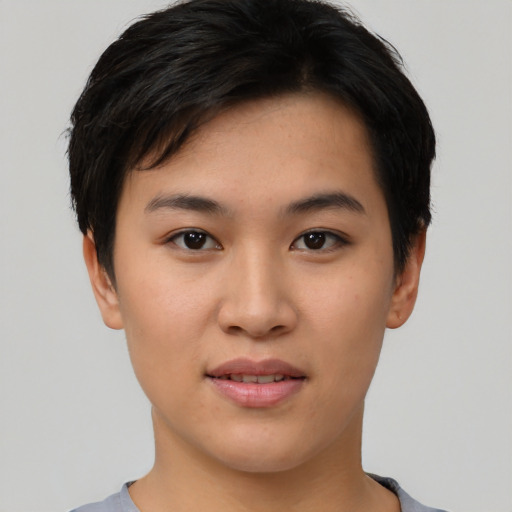Joyful asian young-adult female with short  black hair and brown eyes