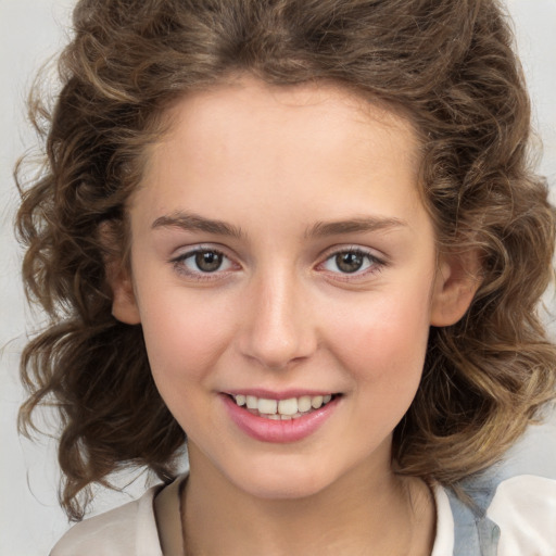 Joyful white child female with medium  brown hair and brown eyes