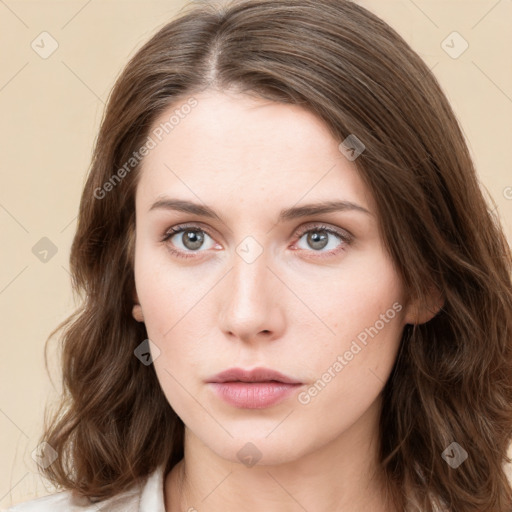 Neutral white young-adult female with long  brown hair and green eyes