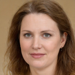 Joyful white young-adult female with long  brown hair and green eyes