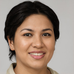 Joyful latino young-adult female with medium  brown hair and brown eyes