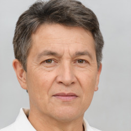 Joyful white middle-aged male with short  brown hair and brown eyes