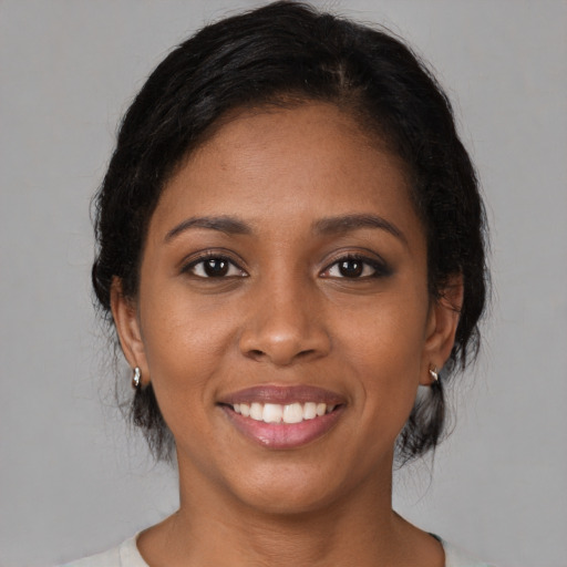 Joyful black young-adult female with medium  black hair and brown eyes