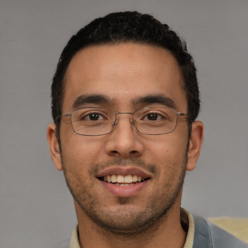 Joyful white young-adult male with short  black hair and brown eyes