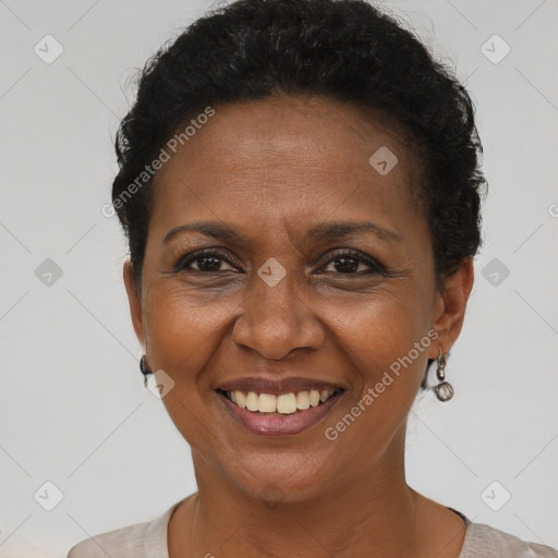 Joyful black adult female with short  brown hair and brown eyes