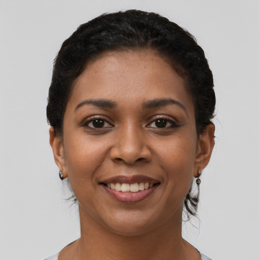 Joyful latino young-adult female with short  brown hair and brown eyes