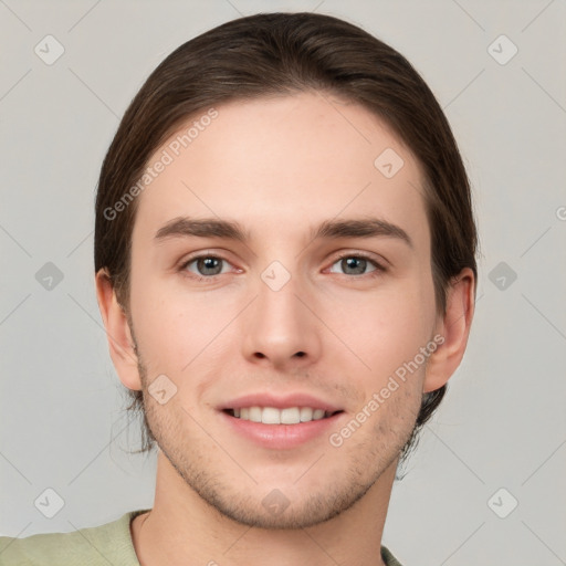 Joyful white young-adult male with short  brown hair and grey eyes