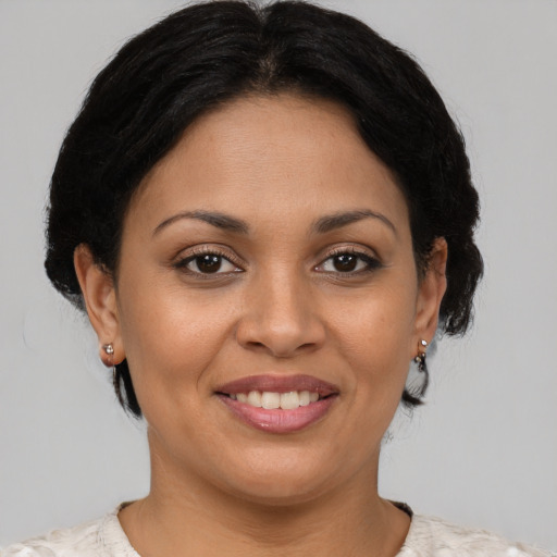 Joyful latino young-adult female with short  brown hair and brown eyes