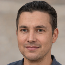 Joyful white adult male with short  brown hair and brown eyes