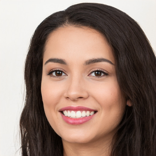 Joyful white young-adult female with long  black hair and brown eyes