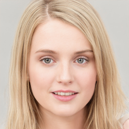 Joyful white young-adult female with long  brown hair and blue eyes