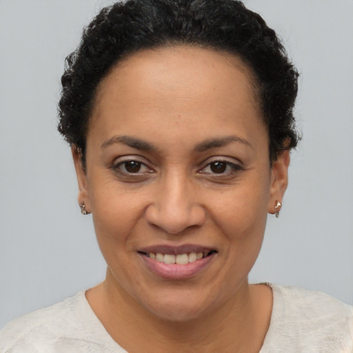 Joyful latino adult female with short  brown hair and brown eyes