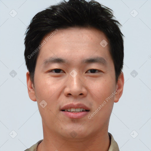 Joyful asian young-adult male with short  brown hair and brown eyes