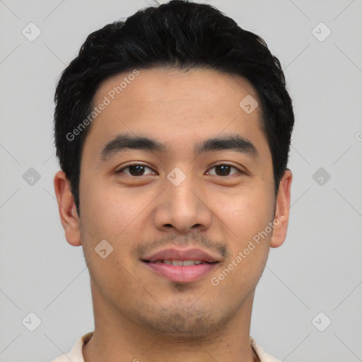 Joyful latino young-adult male with short  black hair and brown eyes