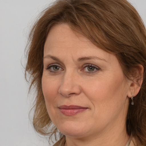 Joyful white adult female with medium  brown hair and brown eyes