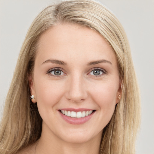 Joyful white young-adult female with long  brown hair and blue eyes