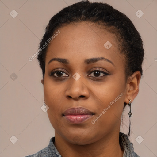 Joyful black young-adult female with short  black hair and brown eyes