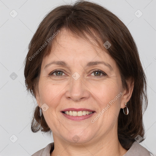 Joyful white adult female with medium  brown hair and grey eyes