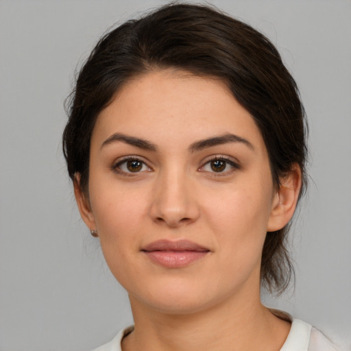 Joyful white young-adult female with medium  brown hair and brown eyes