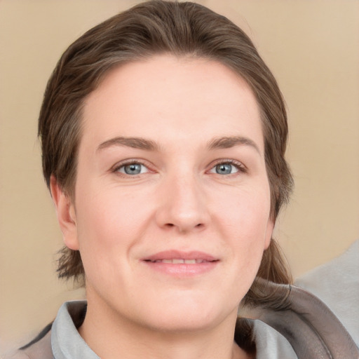 Joyful white adult female with medium  brown hair and grey eyes