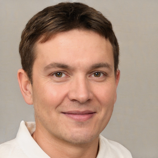 Joyful white adult male with short  brown hair and brown eyes