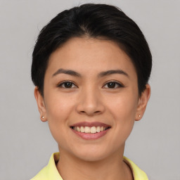 Joyful asian young-adult female with short  brown hair and brown eyes